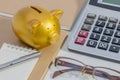 Pig piggy bank, calculator, phone, notebook, pen, glasses, concept of saving money. Royalty Free Stock Photo