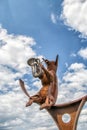 Pig playing a tuba sculpture in a park