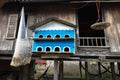 Pigeon dovecot. Bird nesting house hanging in front of old wooden champa house in south of Vietnam