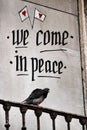 Pigeon perched on a balcony with peace message