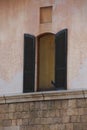 A pigeon perched in an open window Royalty Free Stock Photo