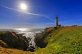 Pigeon Point Lighthouse on Northern California Pacific Ocean coastline just before sunset with an artistic sun flare