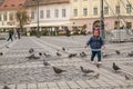 Pigeons and children in Grand Square, Sibiu, Romaniai Royalty Free Stock Photo