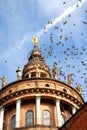 Pigeons in flight above the church Royalty Free Stock Photo
