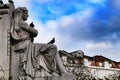 Pigeons perched on granite statue in Lisbon