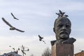 Pigeons sit on the monument to Lenin`s head in the central square of the provincial city