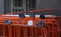 Pigeons sit on orange metal barriers