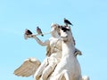 Pigeons sitting on the statue of Renommee Royalty Free Stock Photo