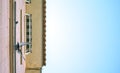 Pigeons standing on the window of a house looking down Royalty Free Stock Photo