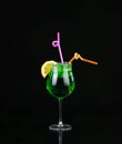 Piggelin Drink, consisting of vodka, melon liqueur and lemon-lime soda. on black Royalty Free Stock Photo
