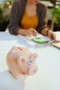 Piggy bank and accountant woman with calculator and documents Royalty Free Stock Photo