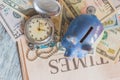 Piggy bank with American dollars and a pocket watch Royalty Free Stock Photo