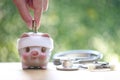 Piggy bank attached to the plaster on the head and stethoscope on green background, Save money for Medical insurance and Health