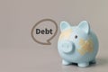 Piggy bank and band aids with text DEBT. Copy space