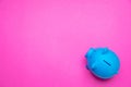 Piggy bank blue color against bright pink background Royalty Free Stock Photo