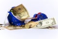 Money bills and coins falling from a broken piggy bank