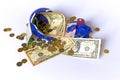 Money bills and coins falling from a broken piggy bank