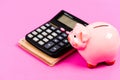 Piggy bank with calculator. Moneybox. bookkeeping. financial report. family budget management. business start up. saving Royalty Free Stock Photo