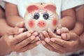 Piggy bank in child kid ,mother and father hands