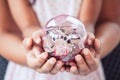 Piggy bank in child kid and mother hands