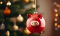 Piggy bank christmas decoration hanging on a Christmas tree branch. Seasonal savings and costs