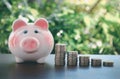 piggy bank with coin on old wooden table on bokeh blur background.concept Royalty Free Stock Photo