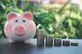 piggy bank with coin on old wooden table on bokeh blur background.concept Royalty Free Stock Photo