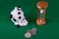Piggy bank, coins and hourglass Royalty Free Stock Photo