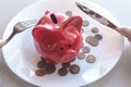 Piggy bank with coins stands on a plate. Cutlery to start eating a dish. Eating savings, consumer savings concept