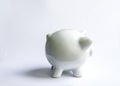 Piggy bank with coins. White ceramic moneybox Royalty Free Stock Photo