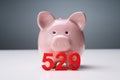 Piggy Bank And 529 College Saving Plan Over Table