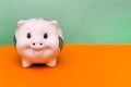 Piggy bank on a colored background. Funny white pig. Investment idea in the form of a toy piggy bank. The concept of saving or Royalty Free Stock Photo