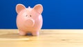 Piggy bank against blue background with copy space. Royalty Free Stock Photo