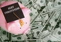 Piggy bank with Debt Forgiveness graduation cap on cash Royalty Free Stock Photo