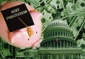 Piggy bank with Debt Forgiveness graduation cap on cash with United States capitol dome Royalty Free Stock Photo