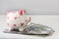 Piggy bank and dollars on white table. Finance. Saving. Royalty Free Stock Photo