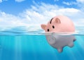 Piggy bank drowning, savings loss concept