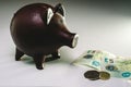 Piggy bank with English money to face savings