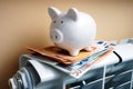 Piggy bank and euro banknotes on the heating radiator. Royalty Free Stock Photo