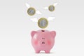 Piggy bank with euro coins flying away - Concept of economy and loss of money