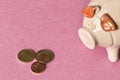 Piggy Bank and a few coins on the orange background. Close up. The concept of saving money. Selective focus Royalty Free Stock Photo