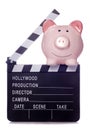 Piggy bank with film clapper board cutout Royalty Free Stock Photo