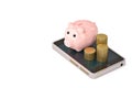 Piggy bank and gold coin stack on Mobile phone.3D illustration. Royalty Free Stock Photo