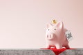 Piggy bank and golden crown standing on red carpet background with saving money words concept. King of savings concept. 3D