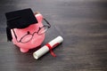 Piggy bank with a grad cap and diploma on wooden table, Education scholarship Royalty Free Stock Photo