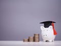 Piggy bank with graduation hat and stack of coins. The concept of saving money for education, student loan, scholarship, tuition Royalty Free Stock Photo