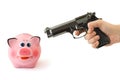 Piggy bank and hand with gun Royalty Free Stock Photo