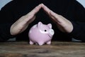 Piggy bank, hand made as an umbrella, financial insurance Royalty Free Stock Photo