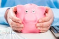 Piggy bank in the hands of its thrifty hostess Royalty Free Stock Photo