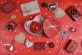 Piggy bank in a heart shape gift box surrounded by hearts, gifts and other love things on red background